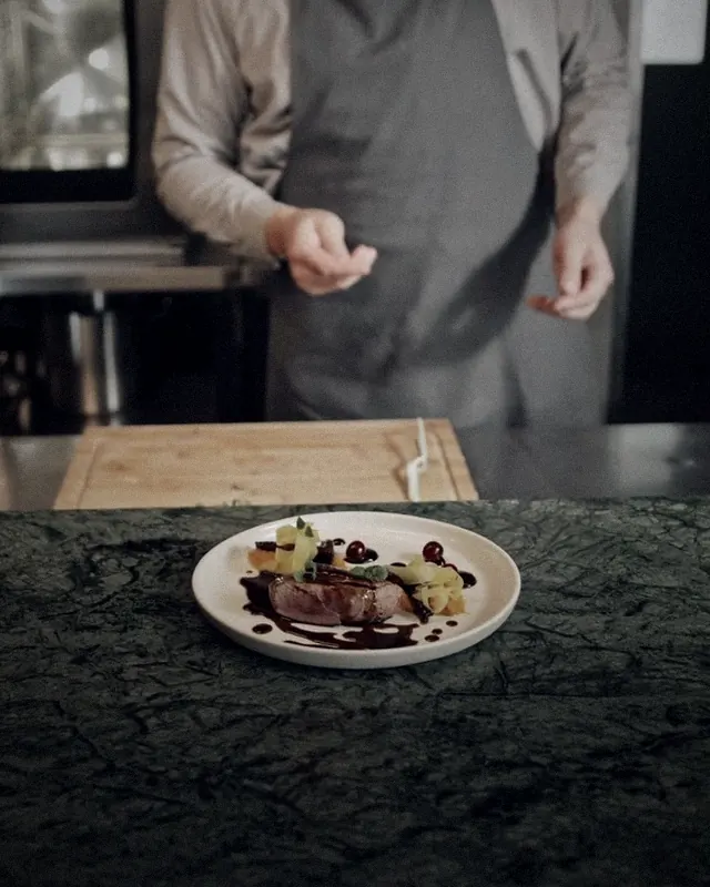 A finished plate on the kitchen pass with a waiting timer
